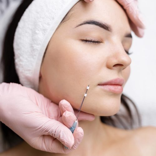 Face lifting PDO Suture operation. innovative technique of New thread lift, cosmetologist preparing to do procedure to female client, select the appropriate thread option.